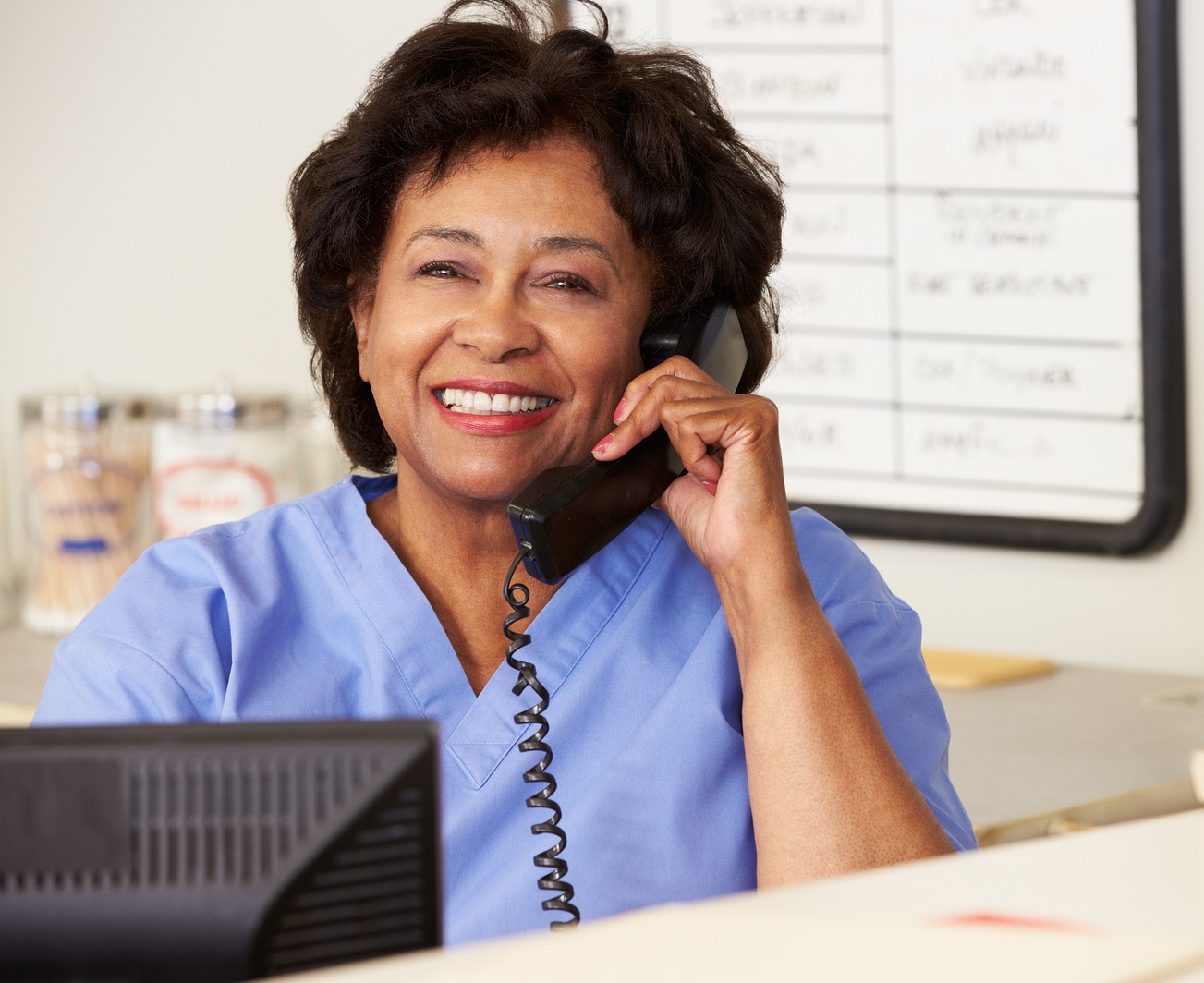 Nurse Making Phone Call At Nurses Station